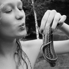 Girl kissing snake